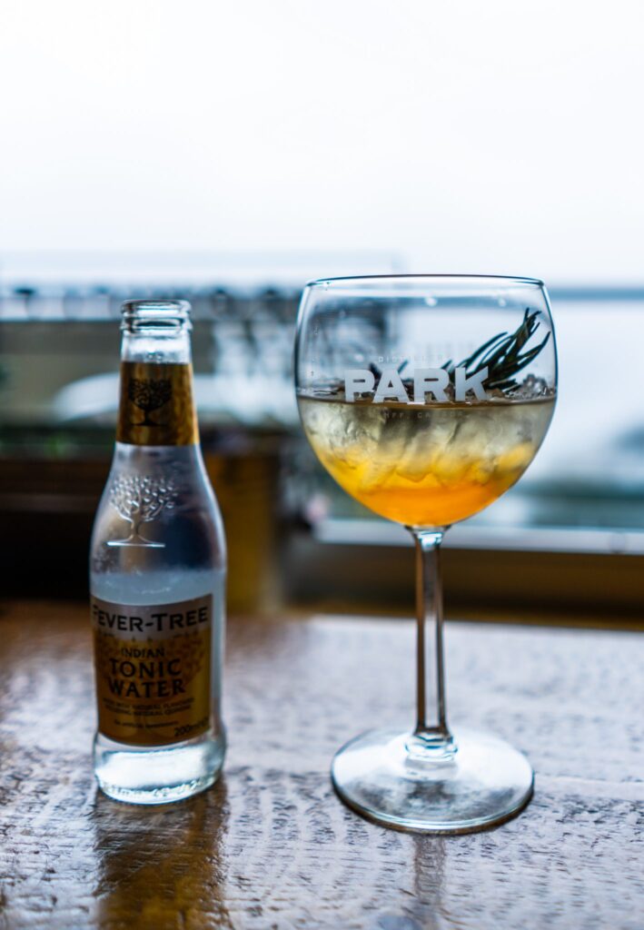 Gin and tonic with rosemary garnish in a copa glass at Cliffhouse Bistro, Banff.