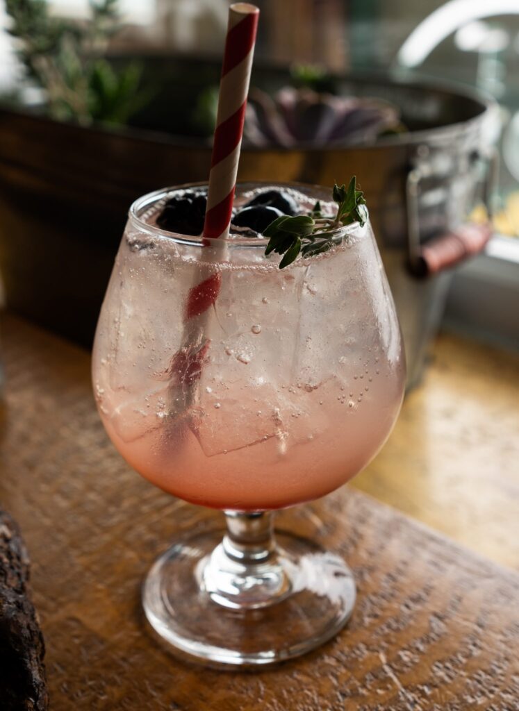Woodbury Gin Bramble cocktail with blackberry and herb garnish at Cliffhouse Bistro, Banff.